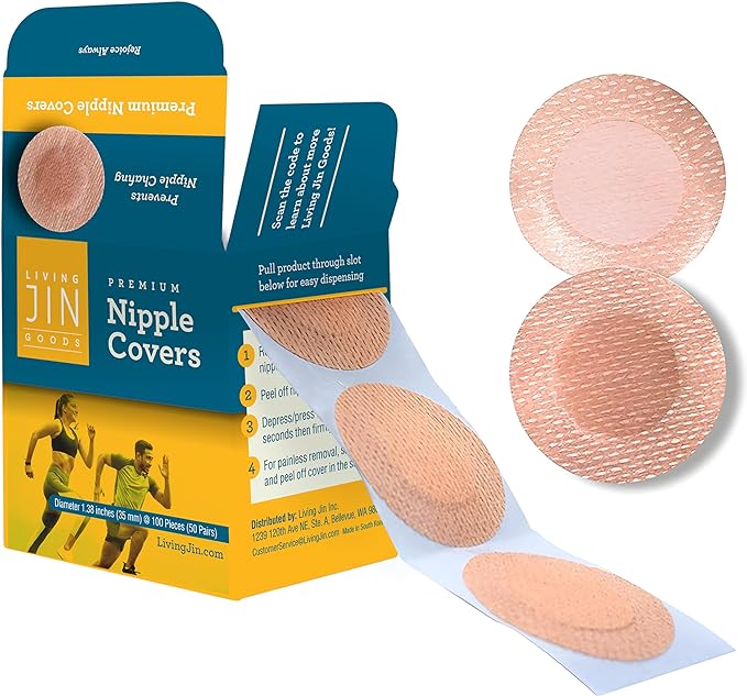An open blue and yellow dispenser box of Living Jin Premium Nipple Covers, showing a strip of circular, skin-toned covers being pulled through the easy-dispensing slot. The image displays the textured, breathable material of the 35 mm diameter covers, which are designed to prevent nipple chafing for runners and athletes.