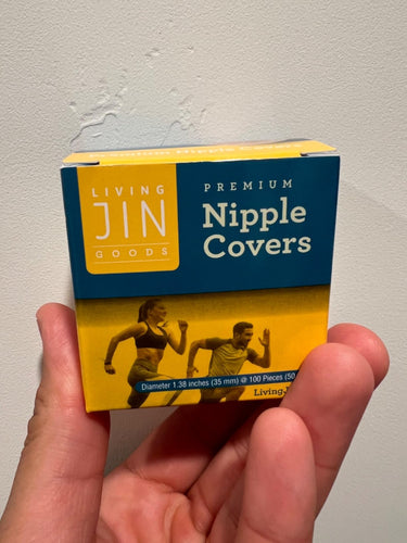 Box of Living Jin Goods Premium Nipple Covers held by a hand against a plain background