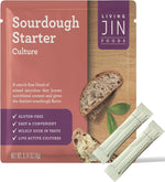 A product display of the Living Jin Sourdough Starter Culture, featuring a 0.14 oz terracotta-colored pouch alongside two individual white starter sticks. The packaging highlights that it is a starch-free blend of mixed microbes designed to boost nutritional content and provide a distinct sourdough flavor, while being gluten-free, easy to use, and containing live active cultures.
