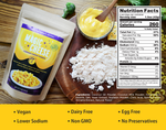 A product information graphic for Living Jin Magic Cheese Cheddar Style Dairy-Free Powder. The image features the product pouch, a bowl of prepared creamy cheese sauce, and the raw powder on a wooden board. A clear "Nutrition Facts" panel and ingredient list are displayed on the right, while a bold yellow footer highlights key product attributes: Vegan, Dairy Free, Egg Free, Lower Sodium, Non GMO, and No Preservatives.